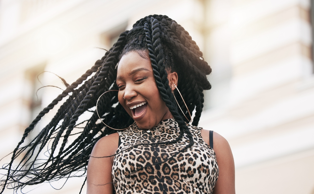 Woman with braids smiling and laughing