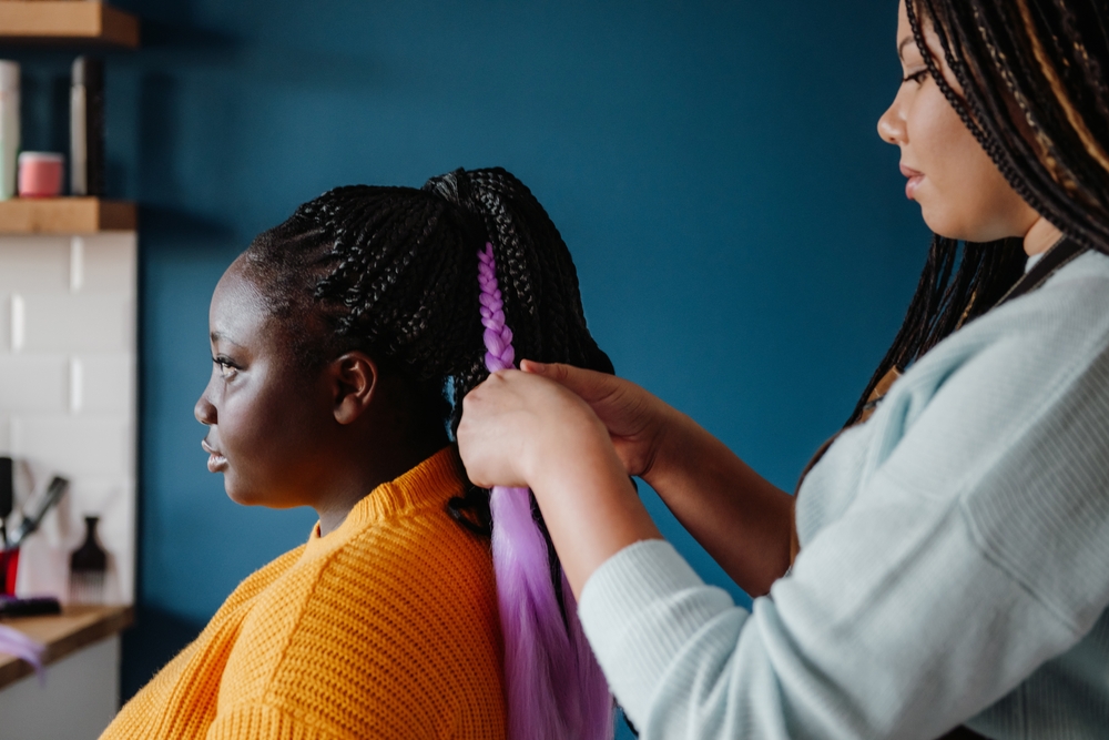Woman braiding hair